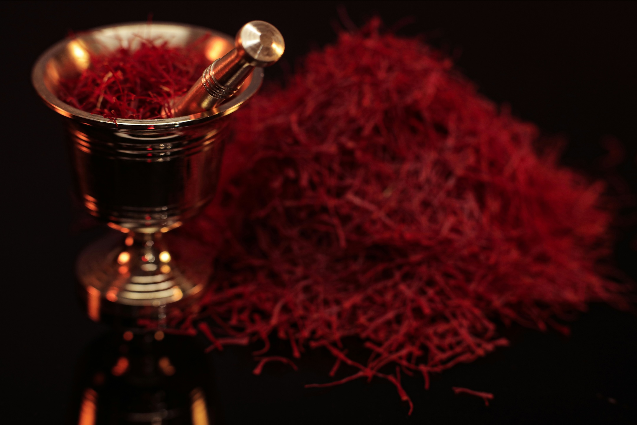 Saffron in gold mortar and pestle