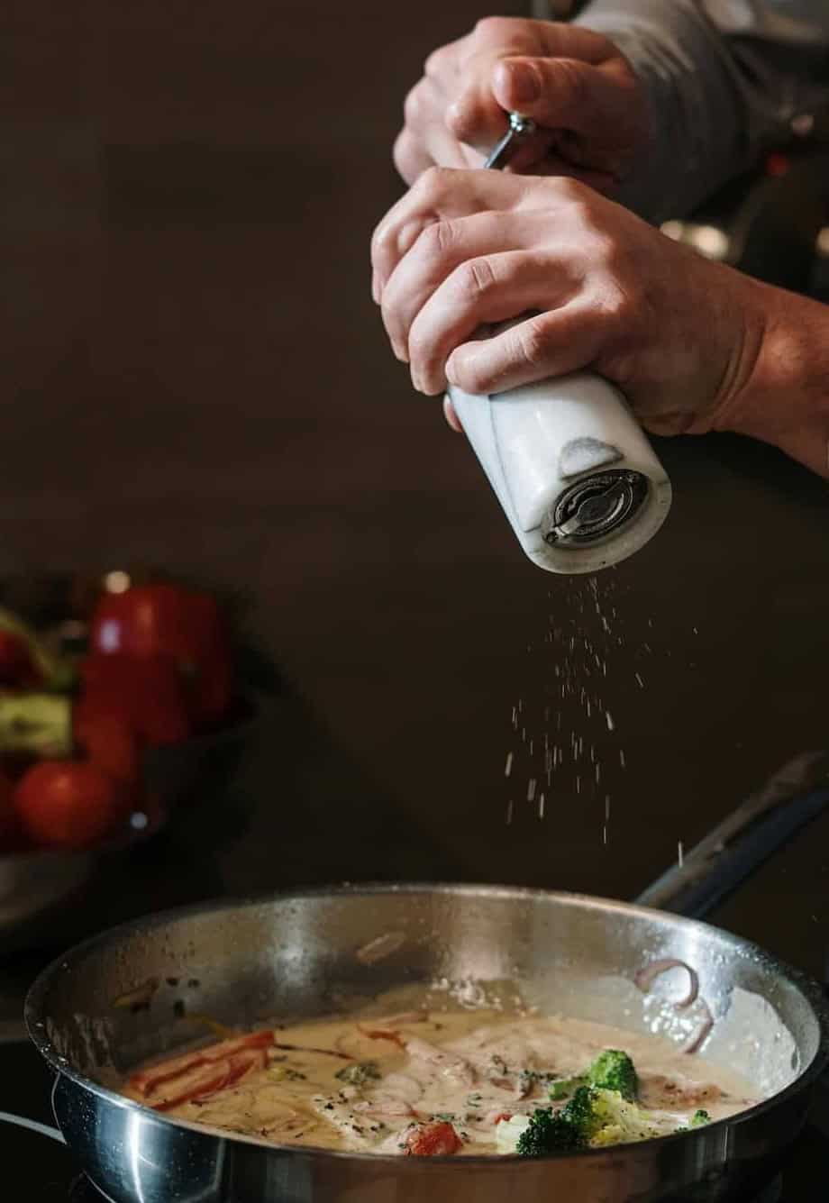 Grinding pepper into pan