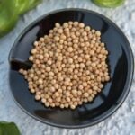 Yellow mustard seed in black dish