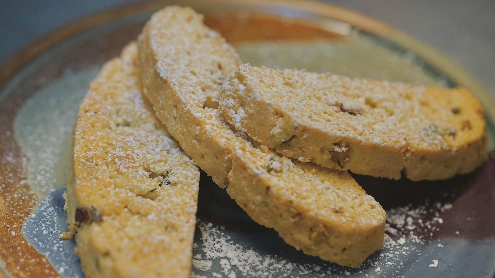 Three pieces of biscotti are on a plate.