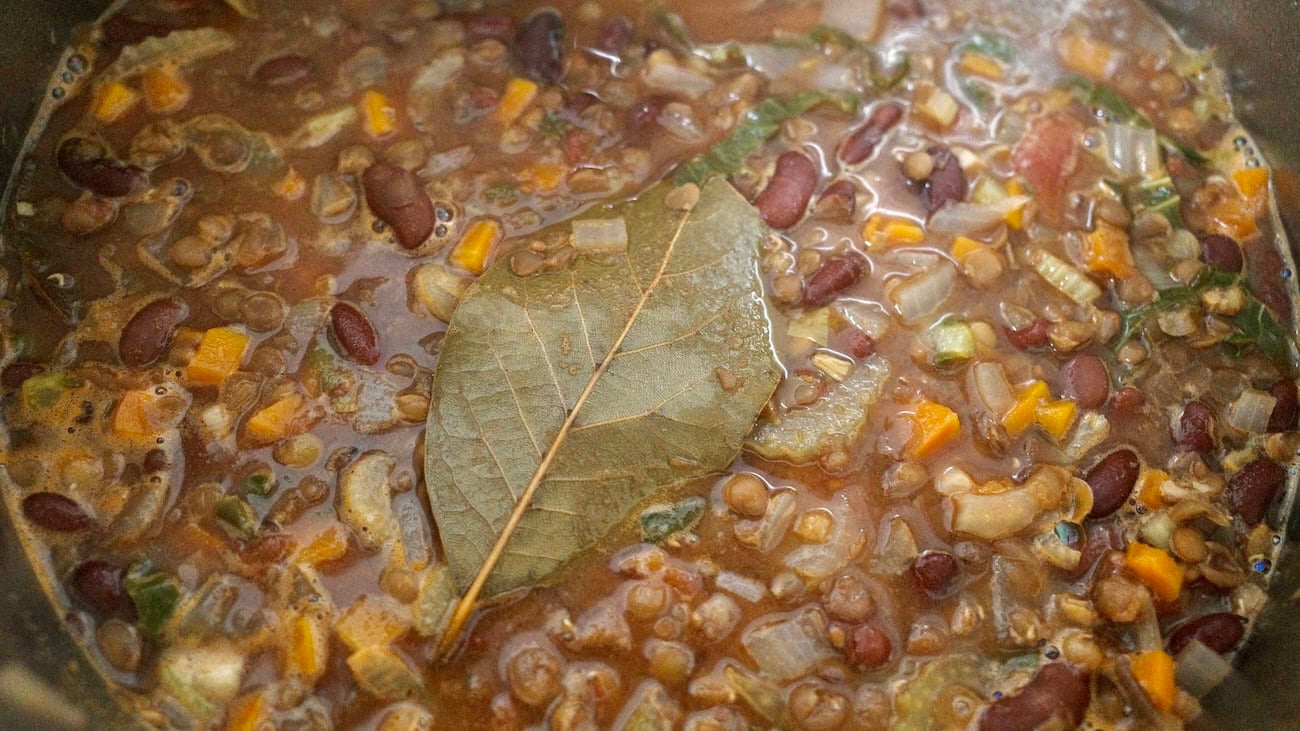 Bay leaf simmering in a pot—bean and veggie soup
