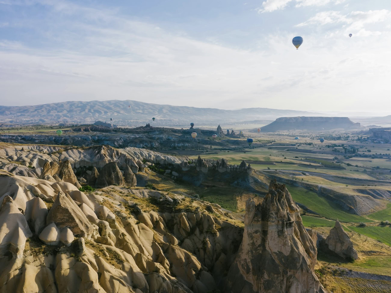 Hot air balloons flying over the rock formations of Cappadocia, Turkey