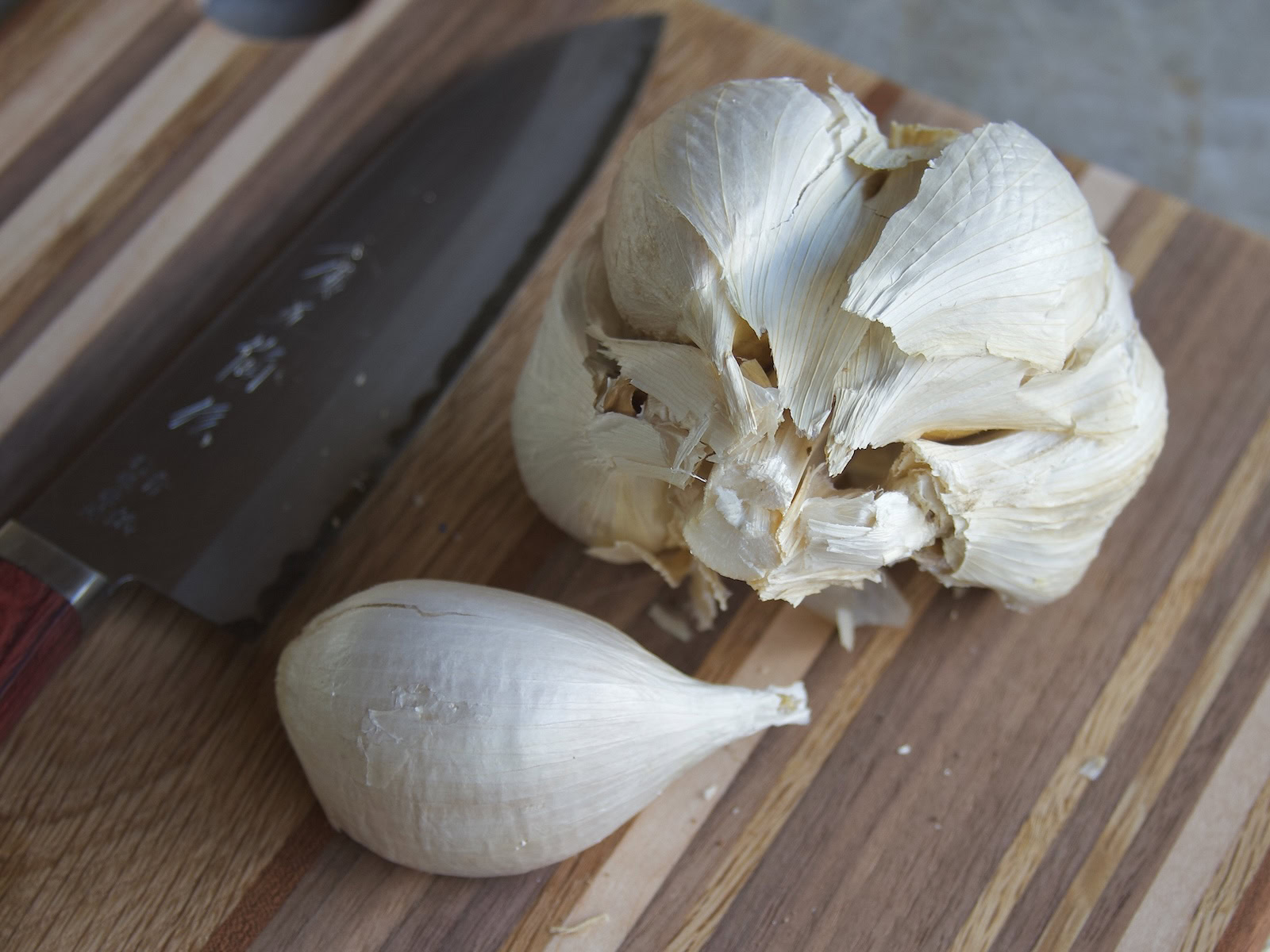 Elephant garlic on cutting board next to Japanese knife