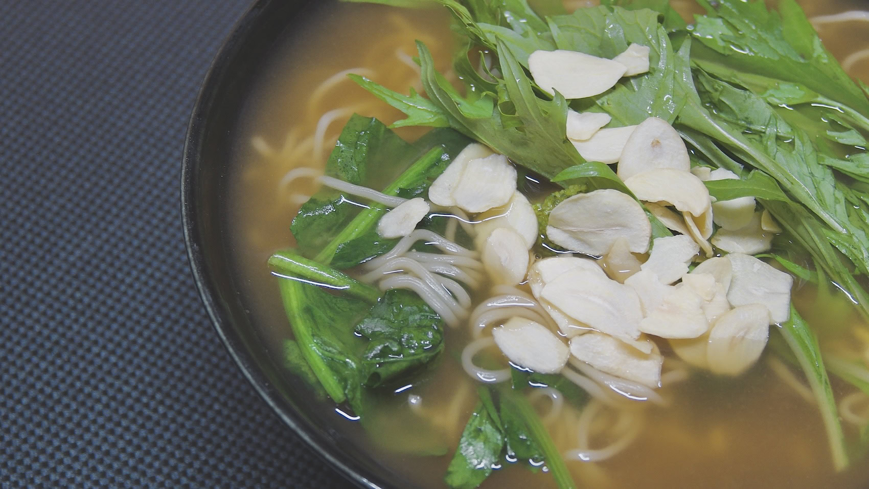 Dried garlic slices with noodles and greens
