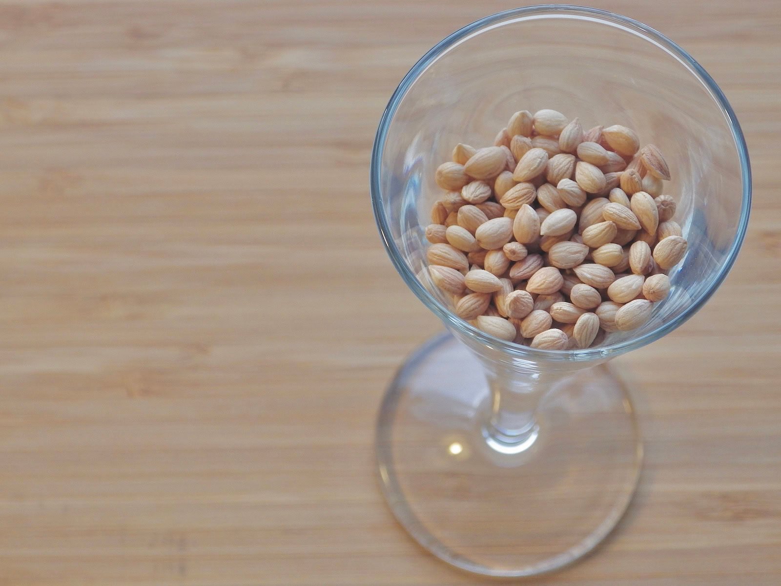 Whole mahlab kernels in a tall glass