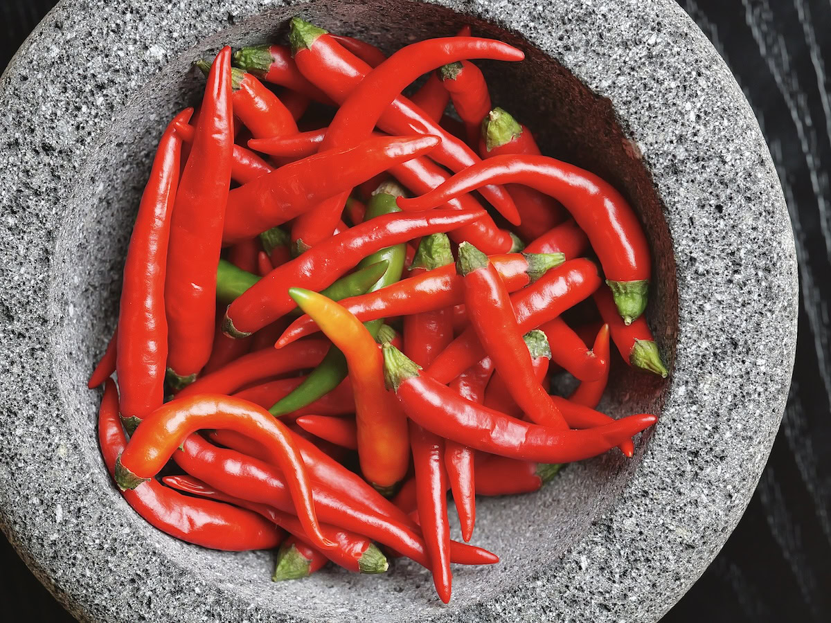 Fresh red hot chile peppers in a molcajete