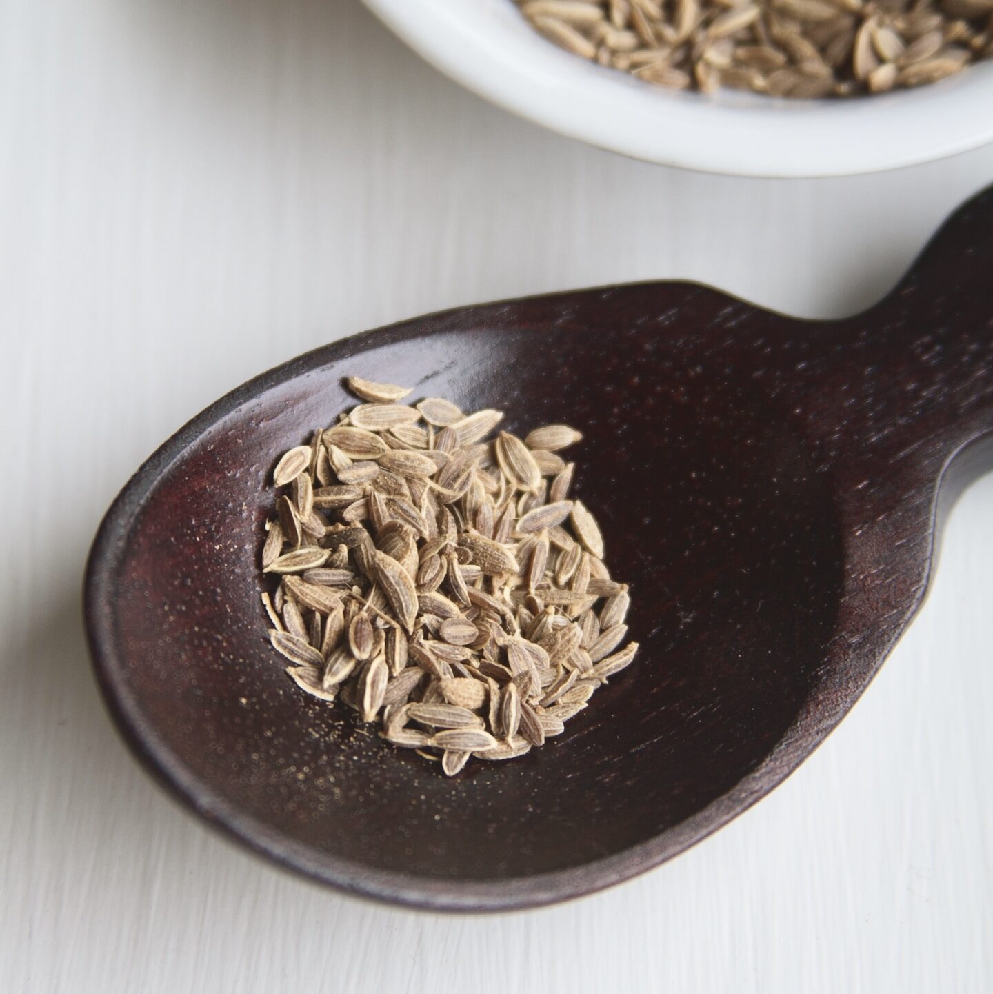 Dill seed in dark spoon