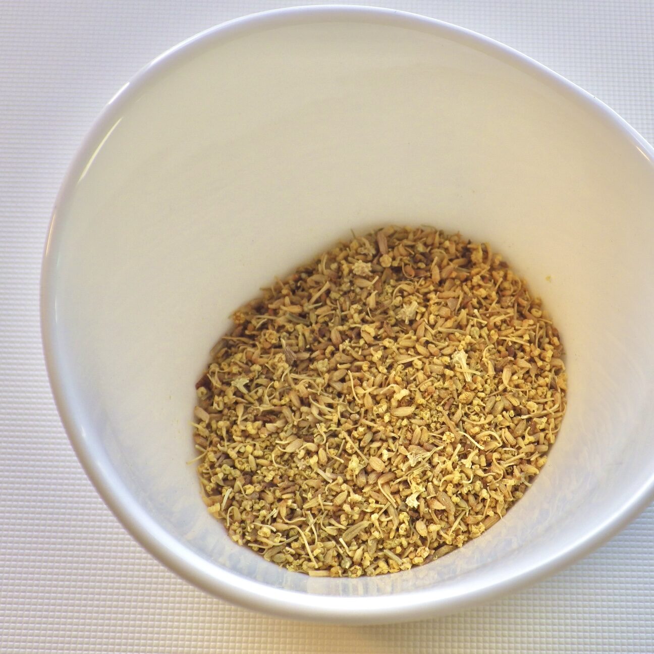 Fennel pollen in large white bowl