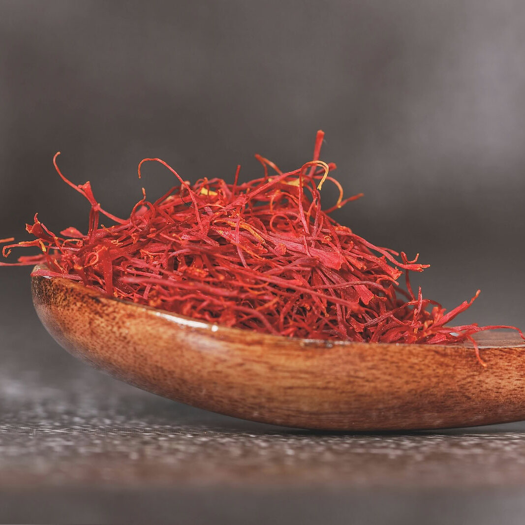 Saffron threads in a polished wooden spoon Saffron threads in a polished wooden spoon
