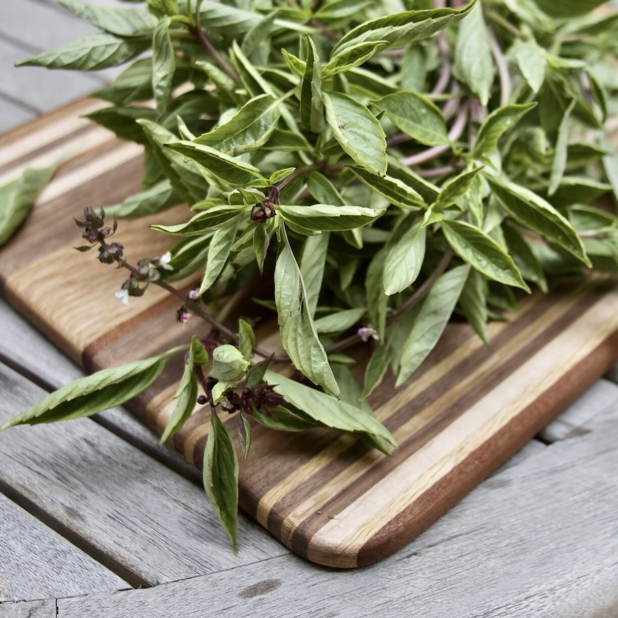 Thai basil on cutting board