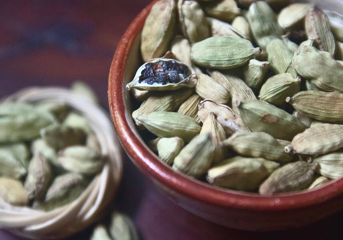 True cardamom in a bowl with one open pod True cardamom in a bowl with one open pod